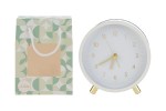 Orologio sveglia bianco circolare con lancette dorate e shopper decorativa coordinata.